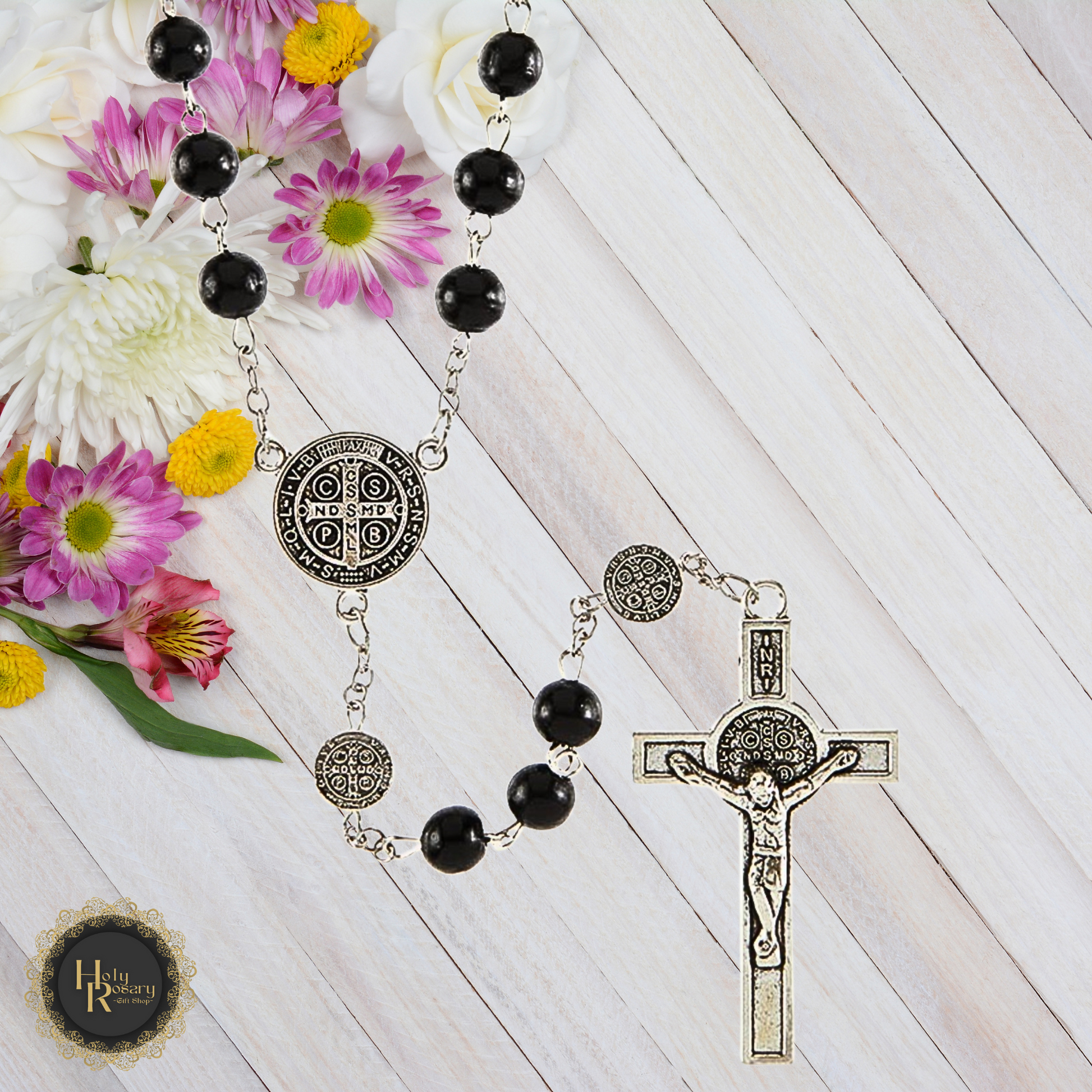 Front view of black rosary beads featuring St. Benedict medals, perfect for devotion and prayer