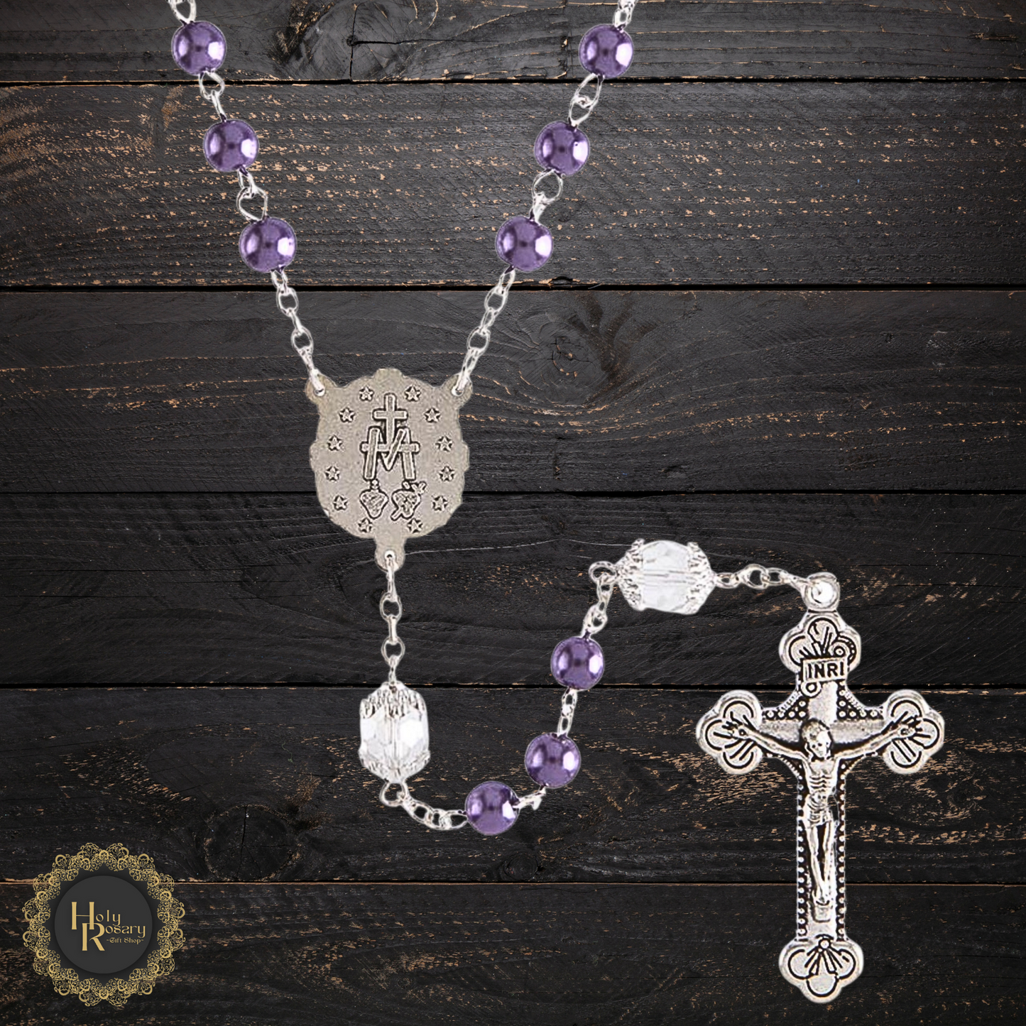 Crystal and purple pearl rosary beads with a silver crucifix and detailed Miraculous Medal centerpiece