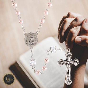 Close-up of Pink Pearl Rosary Necklace showing smooth pink pearls and intricate design