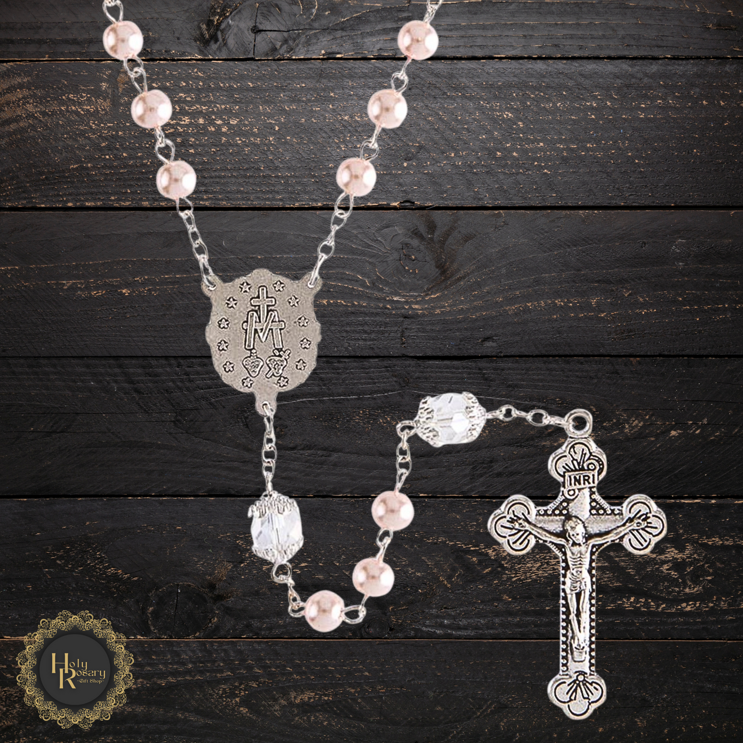 Pink Pearl Rosary Necklace laid out showing its smooth pink pearls and detailed silver cross