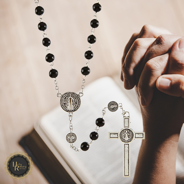 Close-up of black rosary beads with detailed St. Benedict medals and elegant craftsmanship