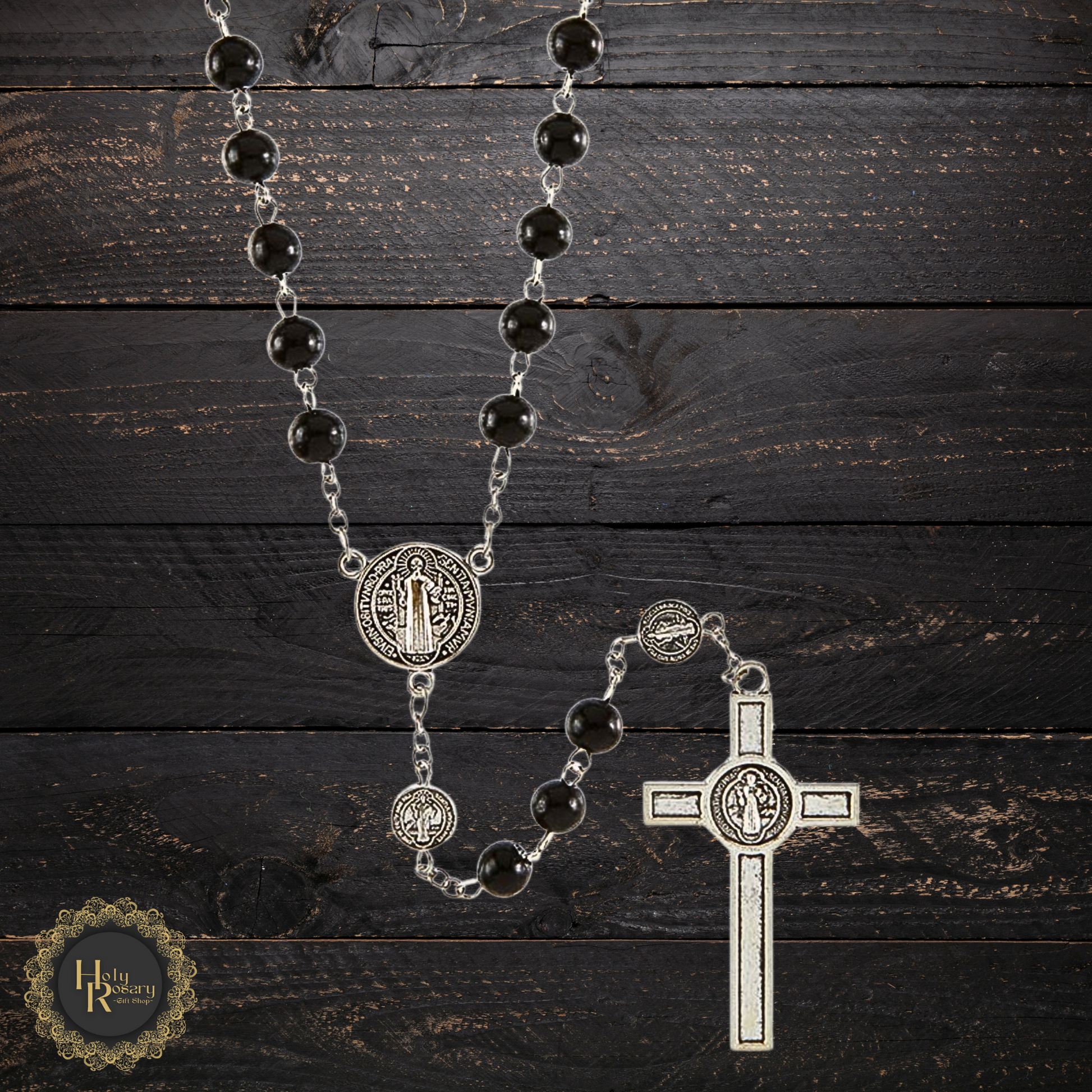 Display of black rosary beads with St. Benedict medals, ideal for gifting