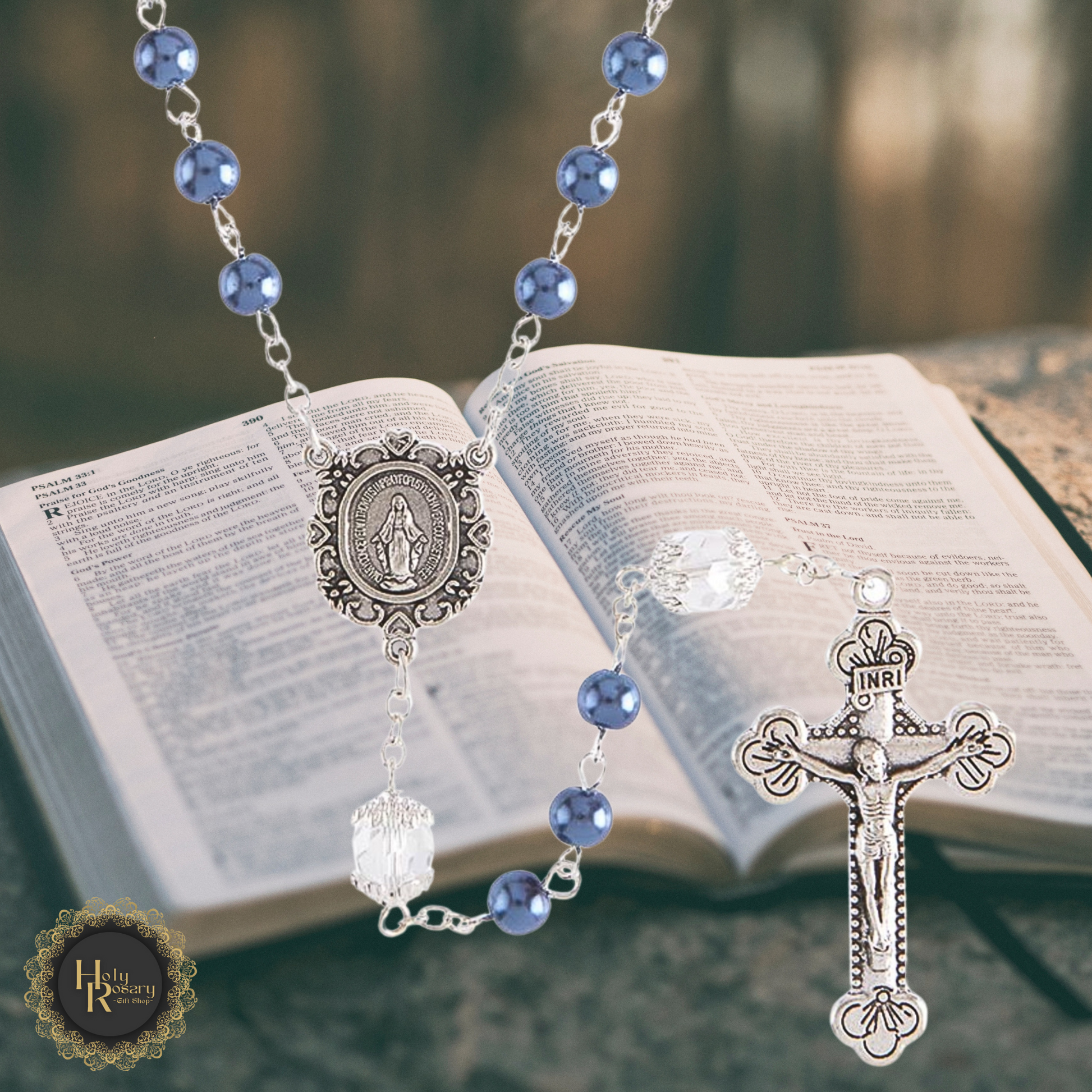 flat lay of a pearl rosary necklace, highlighting the beads and silver crucifix