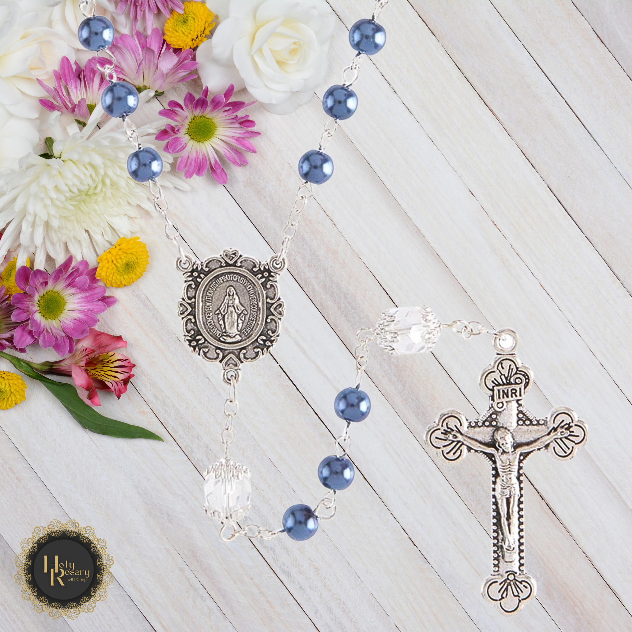 front view of a handcrafted pearl rosary necklace with a detailed Miraculous Medal and silver crucifix