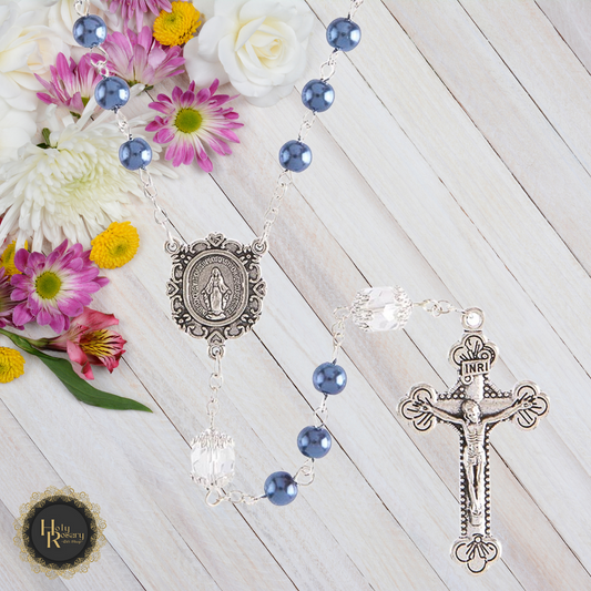 front view of a handcrafted pearl rosary necklace with a detailed Miraculous Medal and silver crucifix