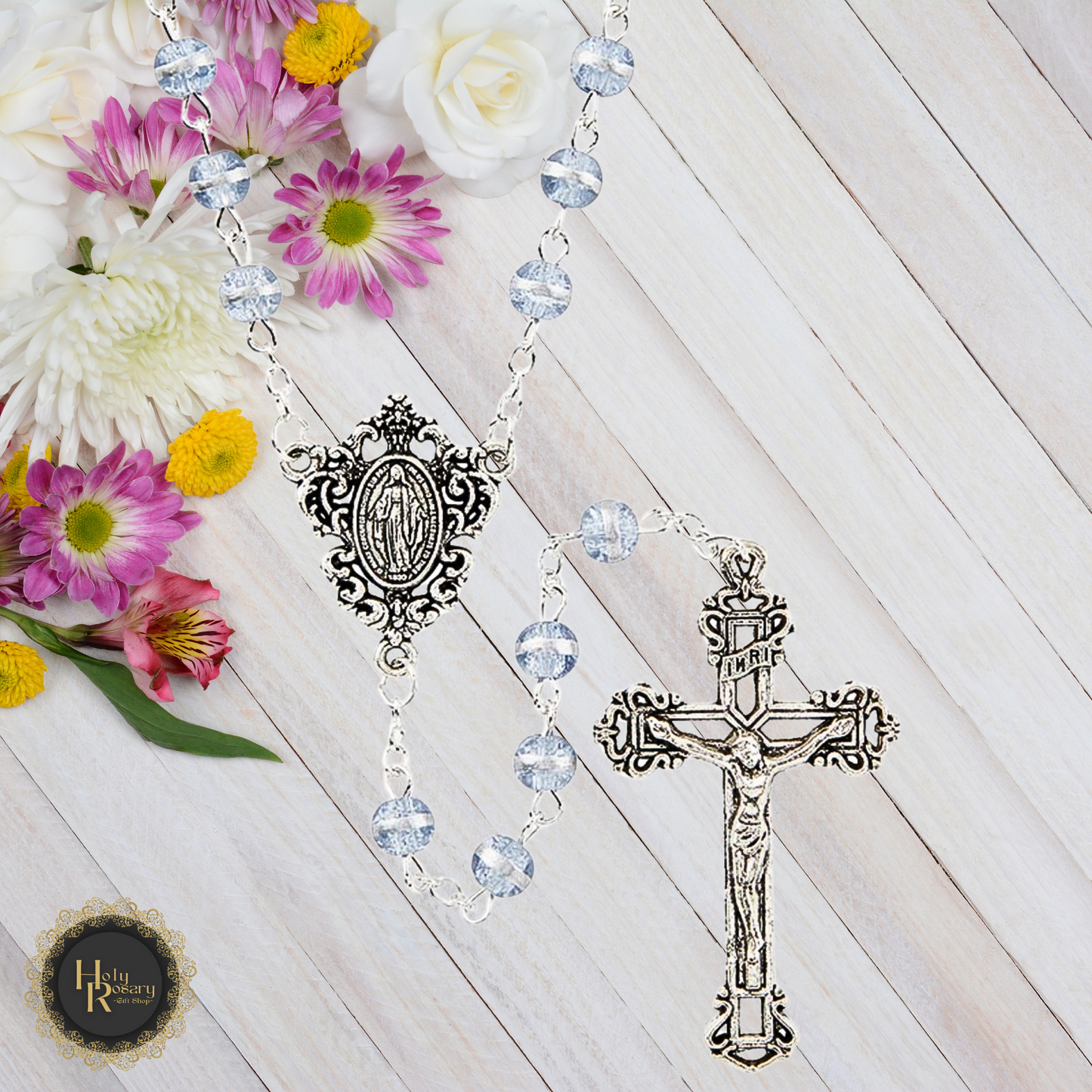 Full view of rosary beads with violet glass, reflective stripes, and a cut-out crucifix.